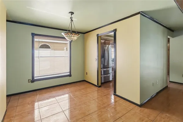 a view of empty room with window and hallway