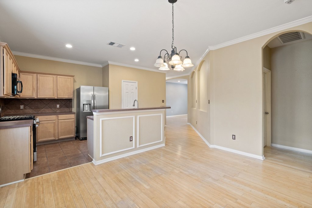 347 Spring Drive Kyle, TX 78640 - Photo 19 of 40 An inviting open-concept layout connects the kitchen with a spacious dining area, perfect for entertaining.