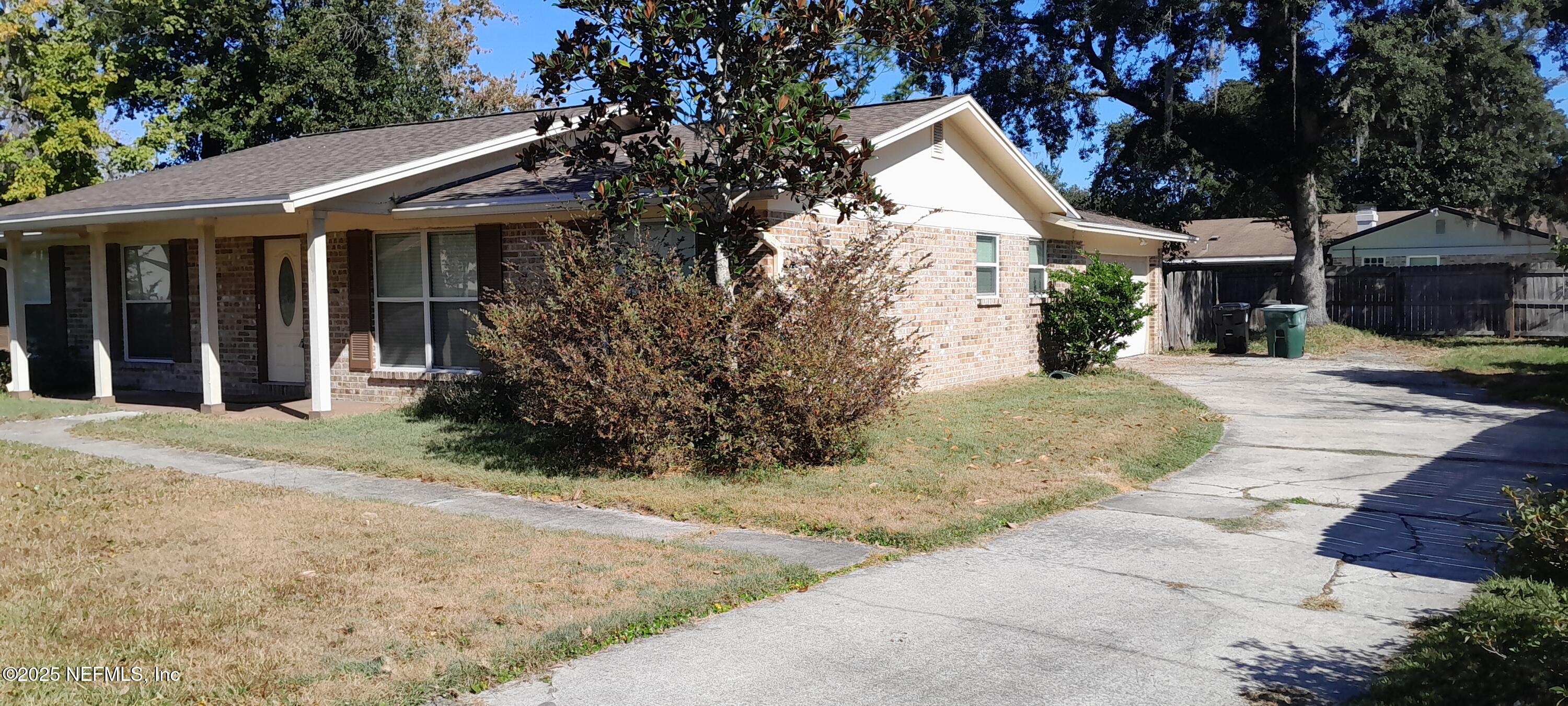 2724 Lexington Drive Orange Park, FL 32073 - Photo 2 of 11 a view of a white house with a large tree