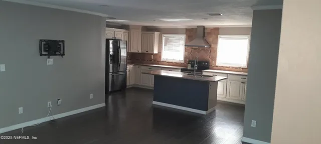 a kitchen with stainless steel appliances granite countertop a sink and a refrigerator