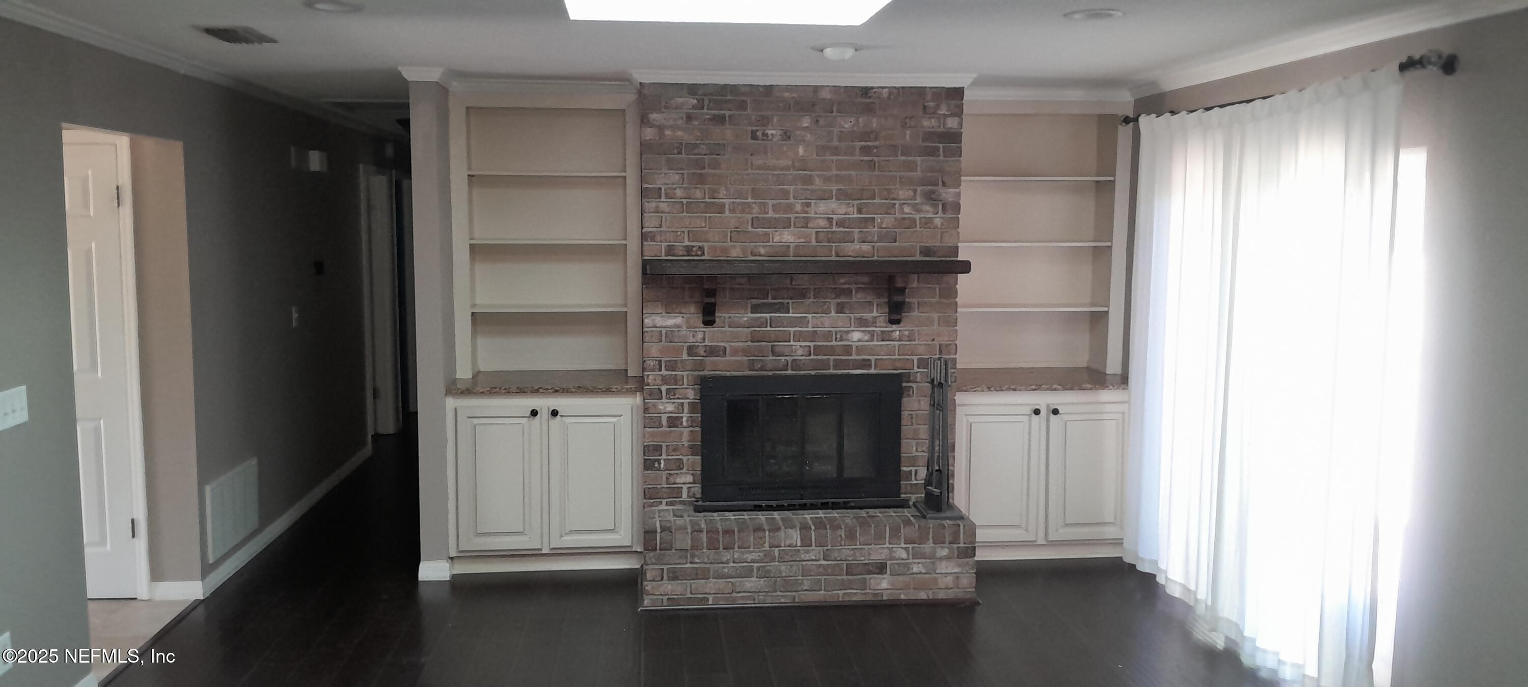 2724 Lexington Drive Orange Park, FL 32073 - Photo 5 of 11 a room with fireplace and wooden floor