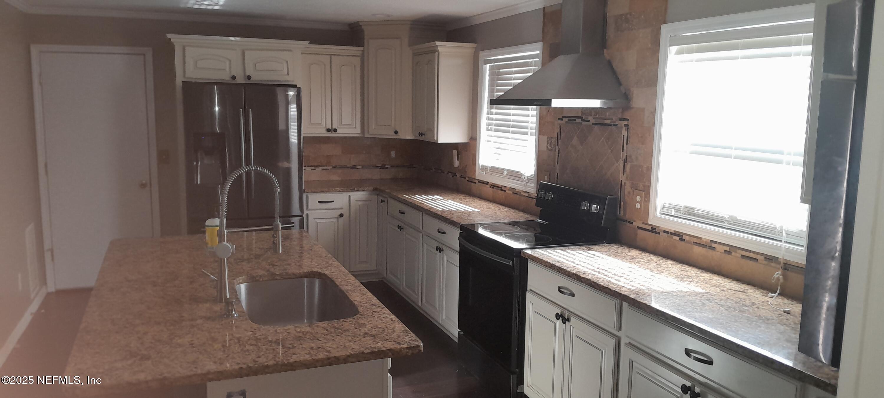2724 Lexington Drive Orange Park, FL 32073 - Photo 7 of 11 a kitchen with stainless steel appliances granite countertop a sink a stove and a refrigerator