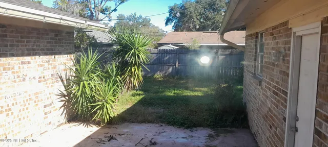 a view of a glass door with a yard