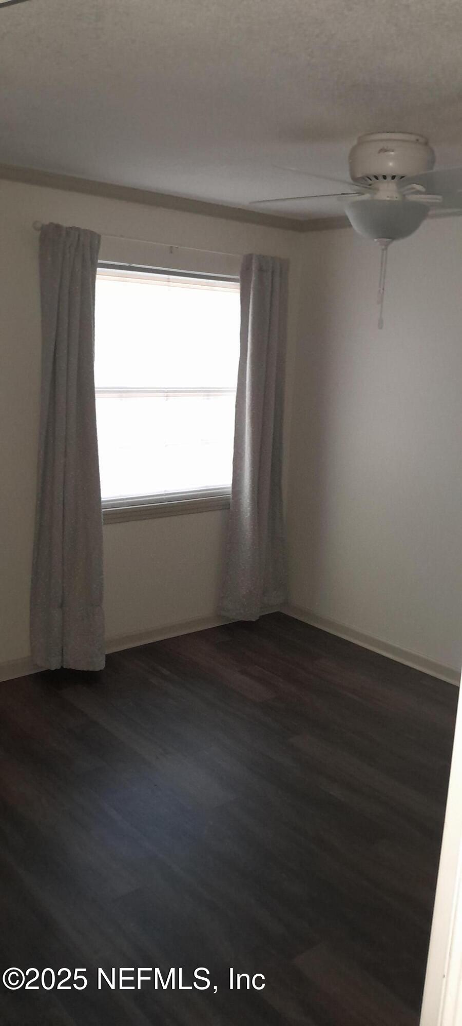 2724 Lexington Drive Orange Park, FL 32073 - Photo 10 of 11 a view of an empty room with wooden floor and a window