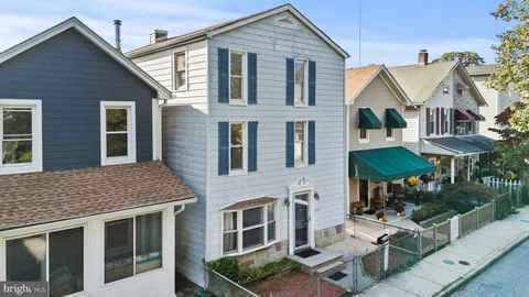 a view of a patio with a table and chairs under an umbrella