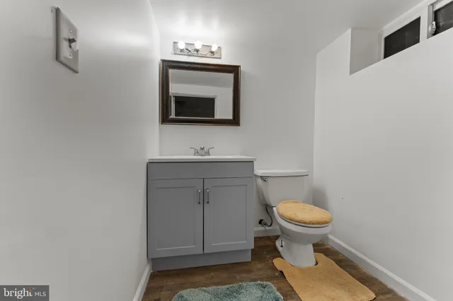 a bathroom with a toilet sink and mirror
