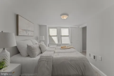 a bedroom with a large bed and a window