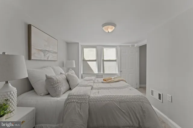 a bedroom with a large bed and a window