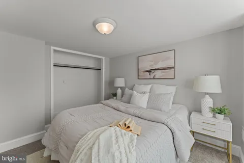 a bedroom with a bed and a lamp