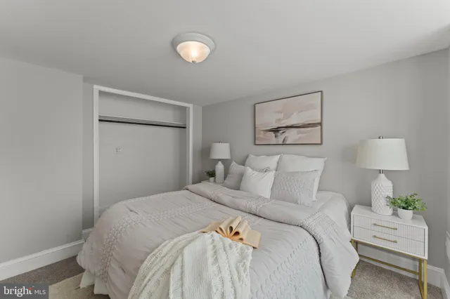 a bedroom with a bed and a lamp