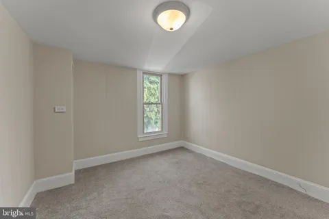 an empty room with a empty space and a window