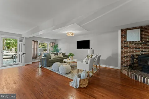 a living room with fireplace furniture and a flat screen tv