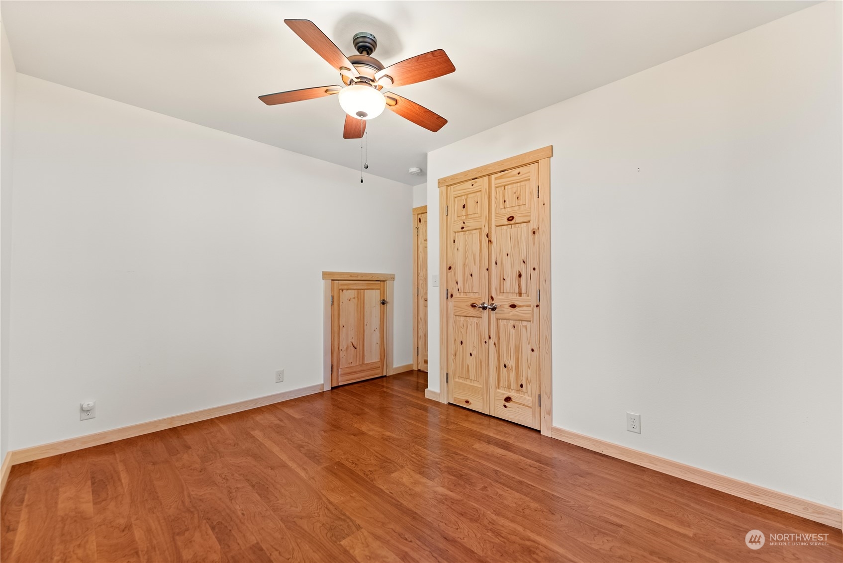 81 Homestead Road Winthrop, WA 98862 - Photo 18 of 39 an empty room with wooden floor and windows