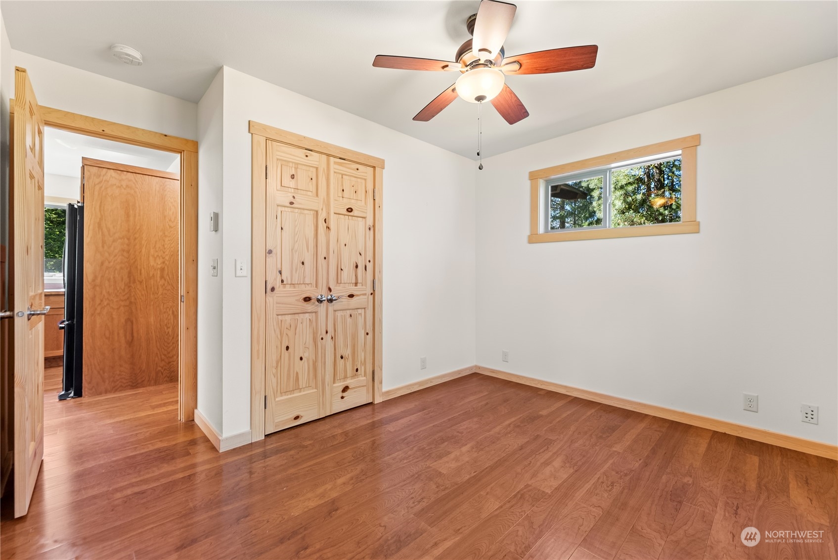 81 Homestead Road Winthrop, WA 98862 - Photo 19 of 39 wooden floor in an empty room with a window