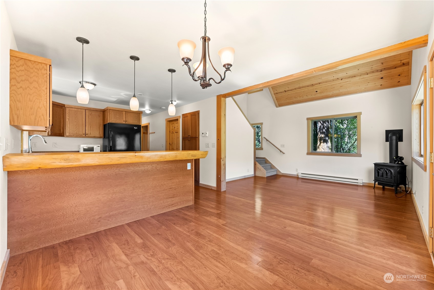81 Homestead Road Winthrop, WA 98862 - Photo 23 of 39 a view of a kitchen with wooden floor and a fireplace
