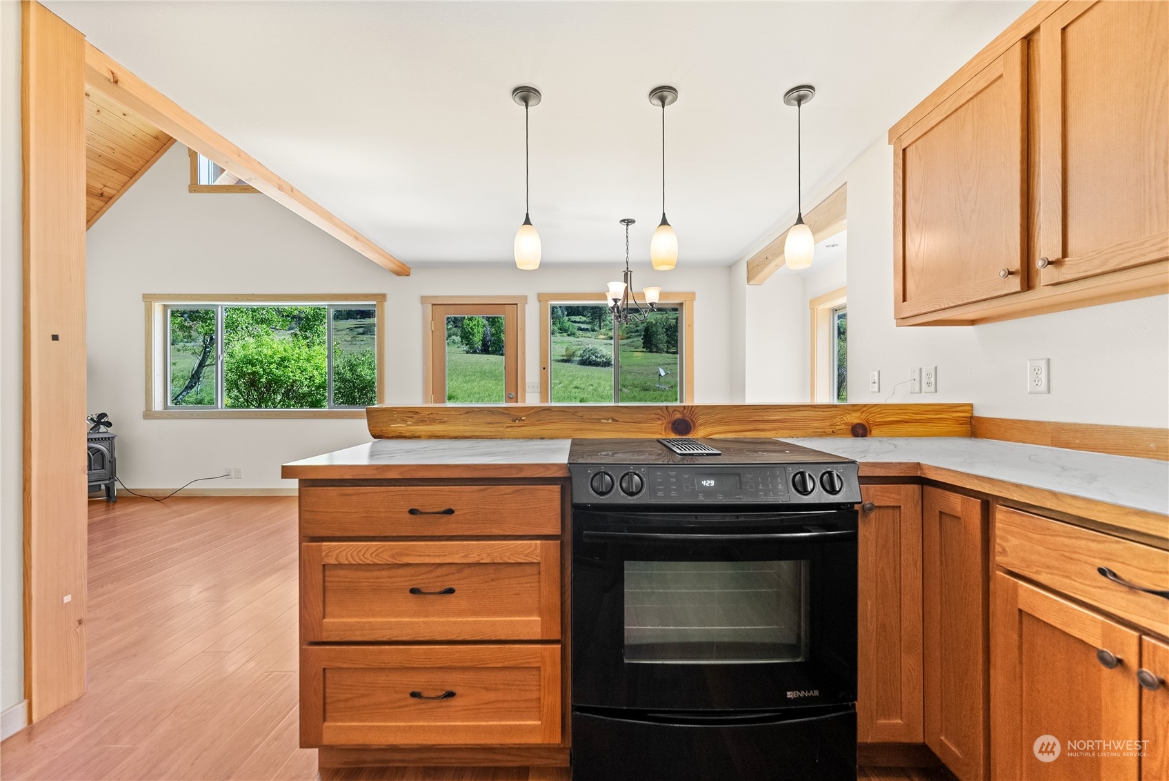 81 Homestead Road Winthrop, WA 98862 - Photo 27 of 39 a kitchen with a stove and a wooden floor