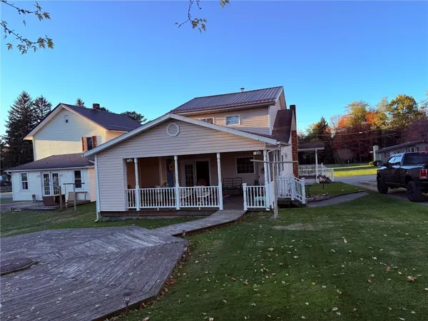 a front view of a house with a yard table and chairs