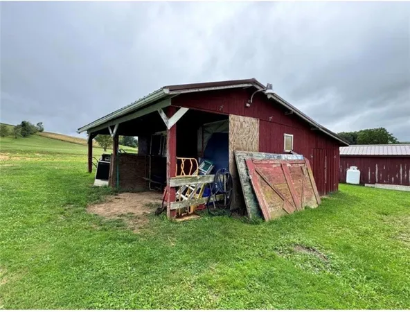 a view of a yard in front of a house with large trees