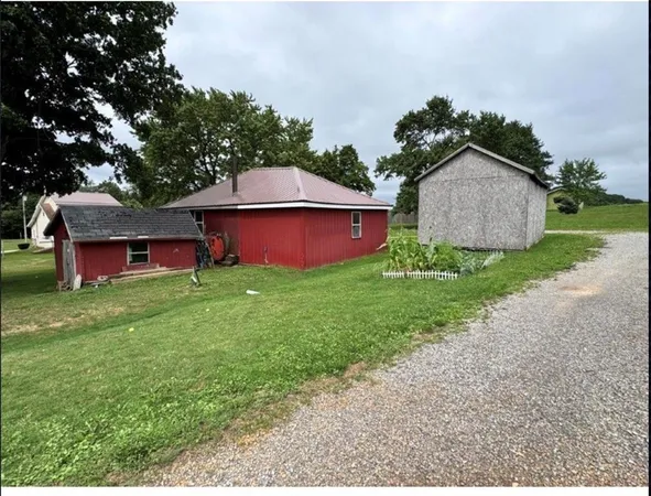 a view of a house with a yard and sitting area