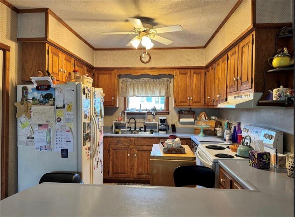 668 Highway 536 Mayport, PA 16240 - Photo 5 of 26 a kitchen with a refrigerator a sink dishwasher and a stove with wooden floor