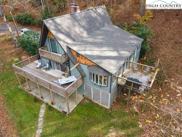 an aerial view of residential house with outdoor space and trees