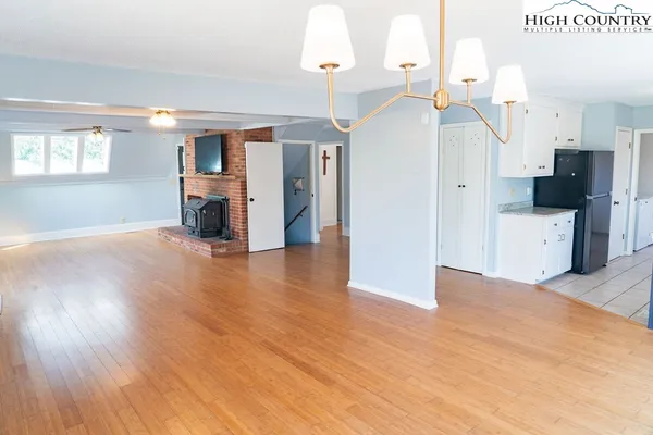 a view of a livingroom with a fireplace and window