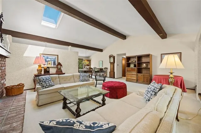 a living room with furniture a rug and a wall painting