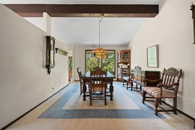a dining room with furniture window and outside view