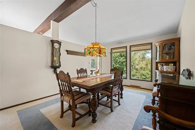 a dining room with furniture a chandelier and wooden floor