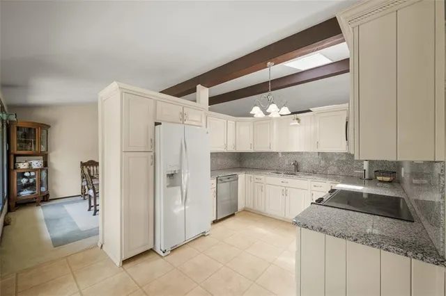 a kitchen with a sink cabinets and refrigerator