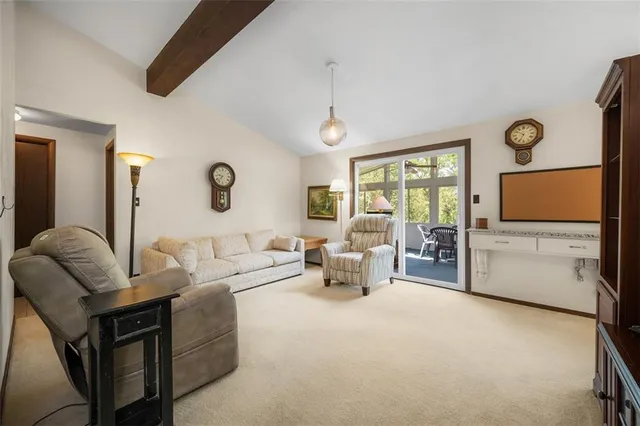 a living room with furniture a window and a flat screen tv