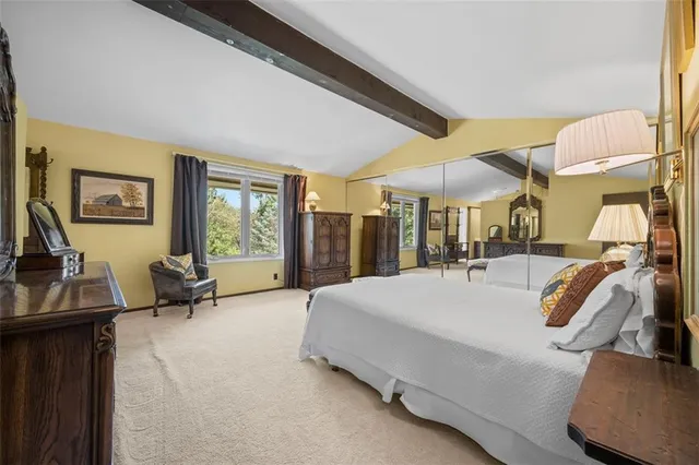 a bed room with a bed and a chair