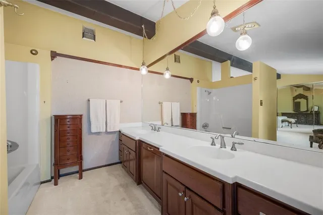 a bathroom with a double vanity sink and mirror