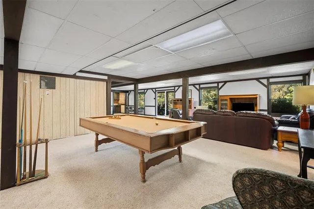 a living room with furniture a rug and a large window