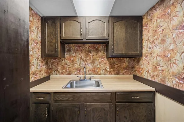 a kitchen with a sink and cabinets
