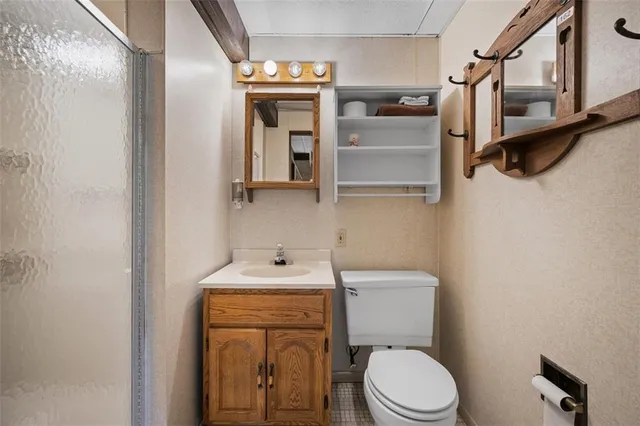 a bathroom with a toilet sink and mirror