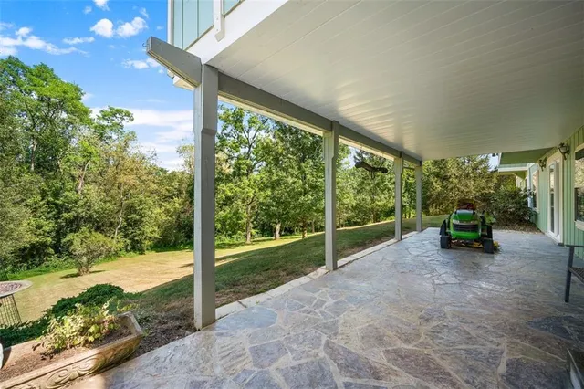 a view of a porch with chairs and backyard