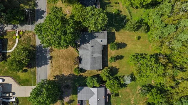 an aerial view of a house with a yard