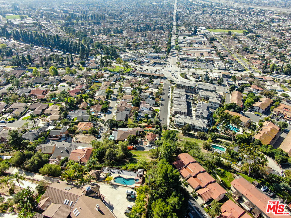 an aerial view of residential houses with city view