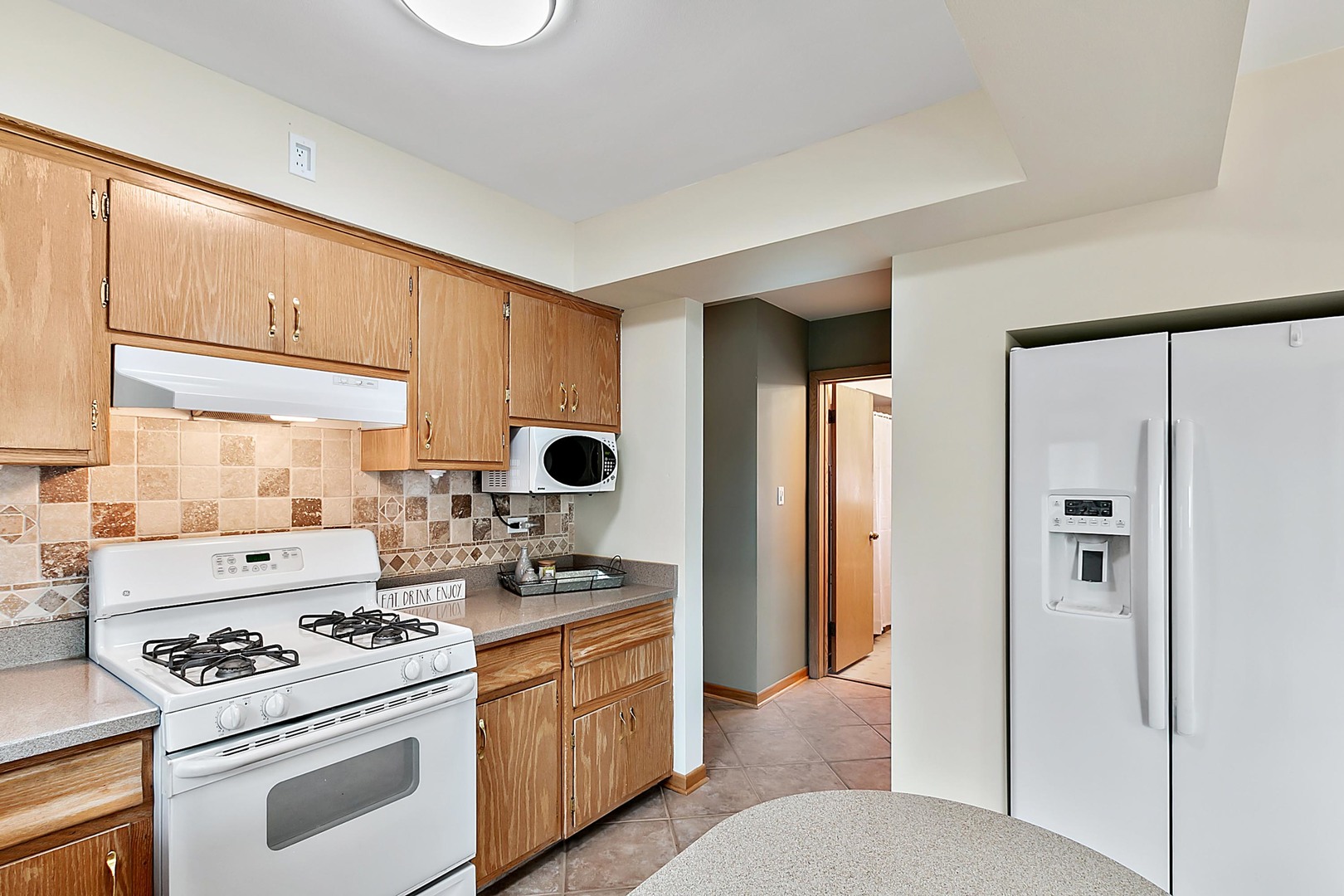4031 Custer Avenue Lyons, IL 60534 - Photo 12 of 19 a kitchen with stainless steel appliances a stove a refrigerator and cabinets