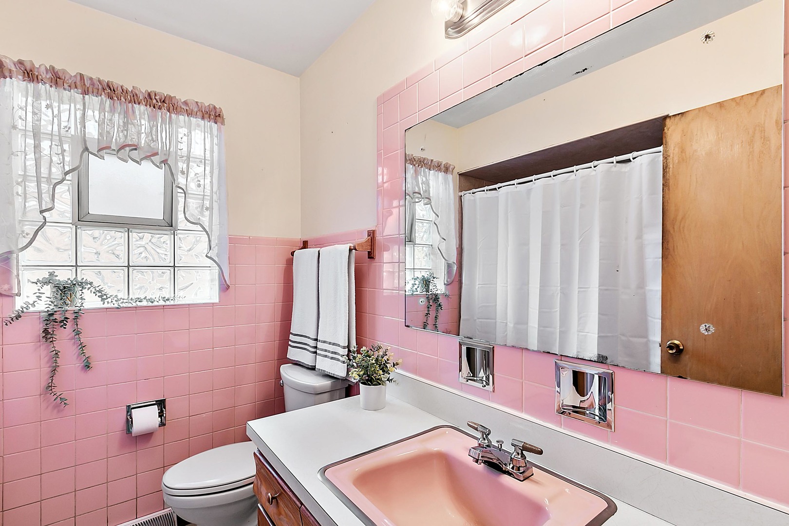 4031 Custer Avenue Lyons, IL 60534 - Photo 16 of 19 a bathroom with a sink a toilet and shower curtain