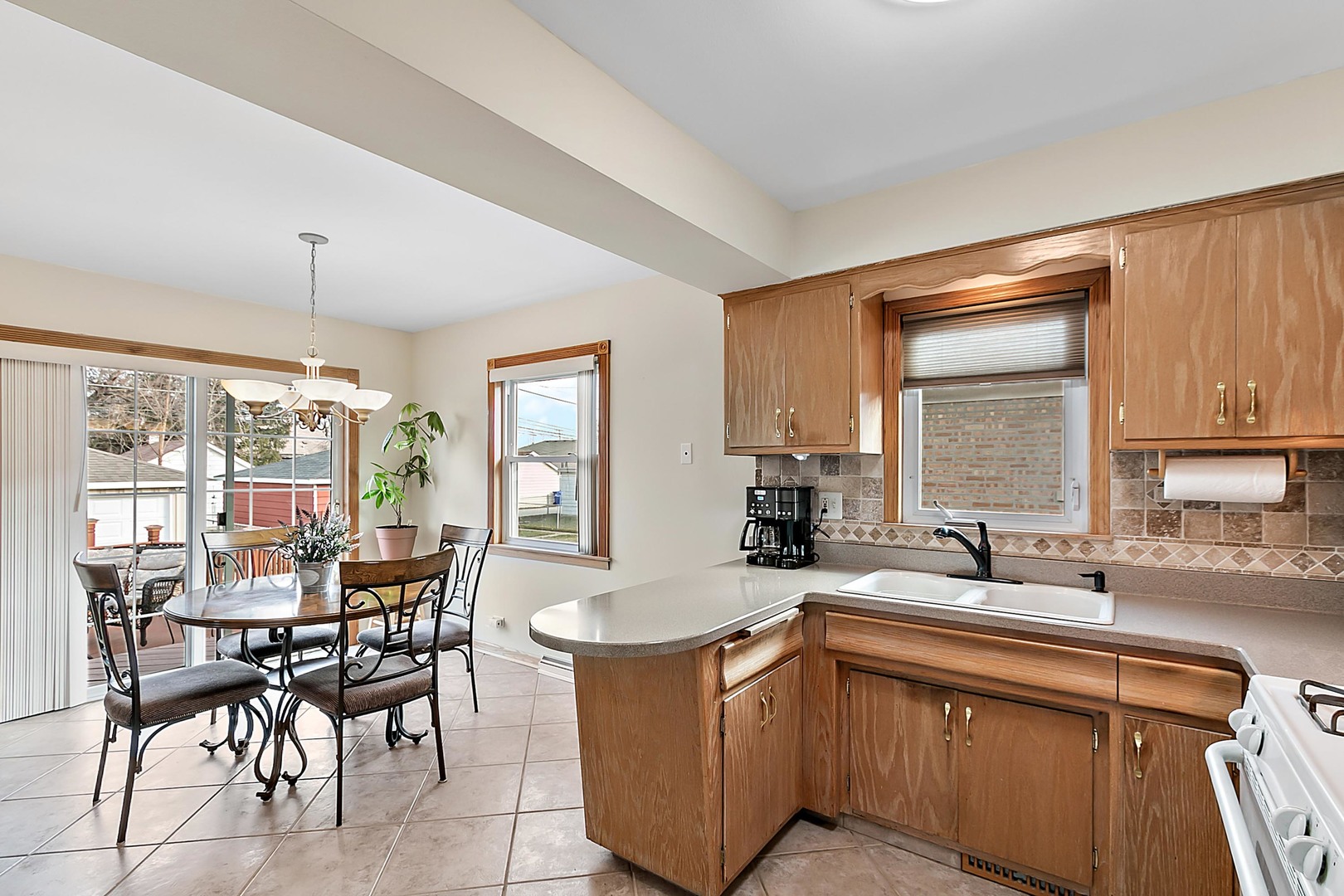 4031 Custer Avenue Lyons, IL 60534 - Photo 10 of 19 a kitchen with sink a table and chairs