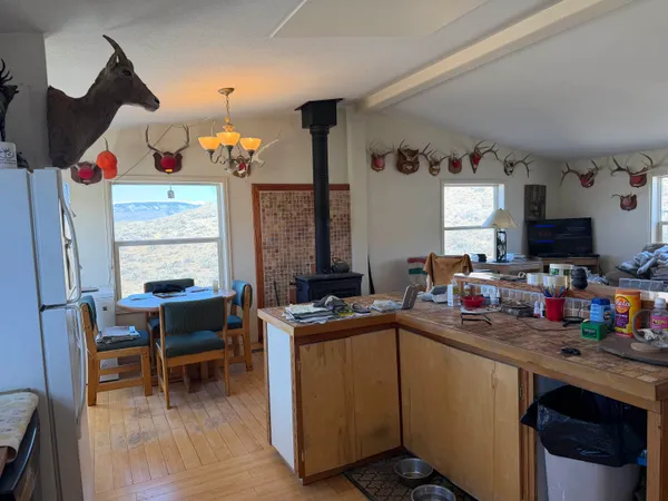a kitchen with a sink cabinets and wooden floor