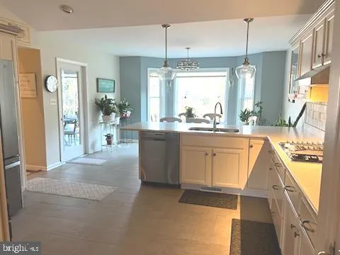 a kitchen with a sink stove and cabinets