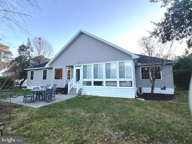 a front view of a house with a garden and yard