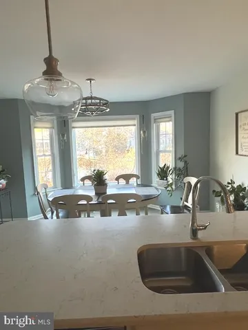 a kitchen with a sink and chandelier