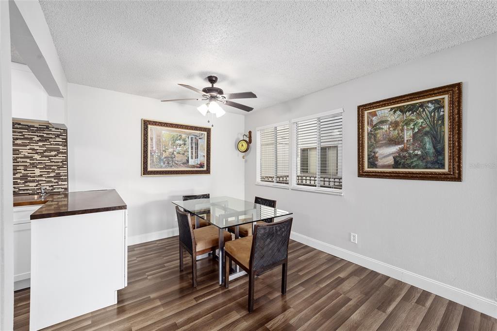 6519 West Newberry Road, Unit 1210 Gainesville, FL 32605 - Photo 8 of 16 a view of a dining room with furniture window and wooden floor