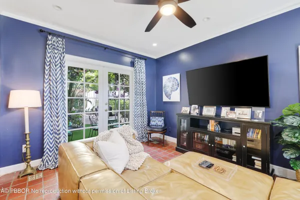 a dining room with furniture a chandelier and wooden floor