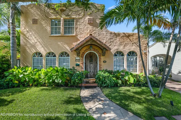 a front view of a house with garden