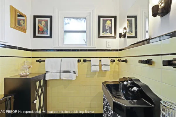 a view of a patio with couches table and chairs under an umbrella with a barbeque
